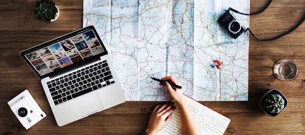 A person planning a trip with a map